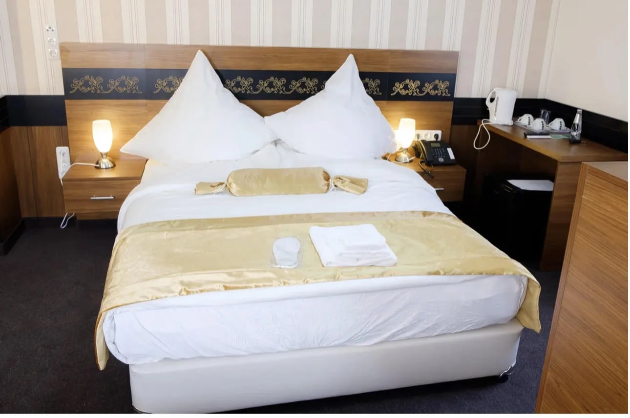 Doppelzimmer mit Doppelbett, Nachttischen und Schreibtisch mit Kaffeestation